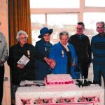 Cutting a cake to celebrate in the old school hall